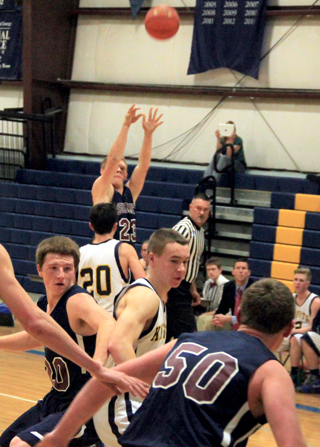 Nathan Beckman shoots from 3-point range as Josh Lustig, left, and Chris Osborne, 50 vie for rebounding position.