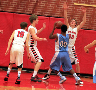 Tanner Ross and Lucas Arnzen defend against Lapwai as Bryson Higgins looks on from the left.