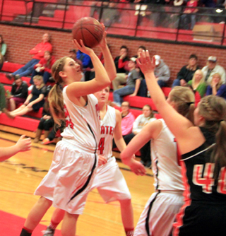 Kylie Tidwell shoots against Troy. Also shown are Shayla VonBargen behind Tidwell and Kayla Schumacher to the right.