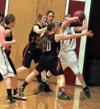 Josie Peery and Hailey Danly double team the Kamiah ballhandler.