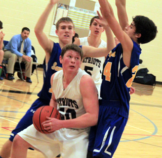 Chris Osborne looks for an opening after making an offensive rebound. Also shown is Dean Stubbers.
