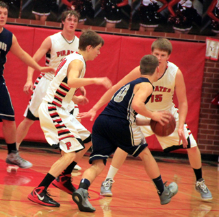 Bryson Higgins and Tanner Ross double-team a Grangeville ballhandler. Lucas Arnzen is in the background.