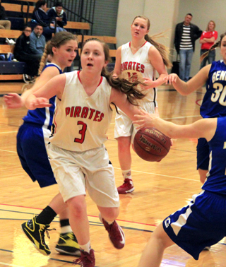 Angela Wemhoff drives into the lane as Kayla Schumacher trails on the play.