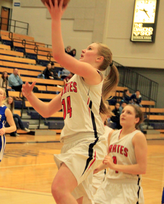 Kayla Schumacher scores on a lay-up against Genesee at District. Also shown is Shayla VonBargen.