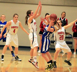 Krystin Uhlenkott is about to force a turnover in the District game against Genesee. Also shown are Shayla VonBargen and Hailey Danly.