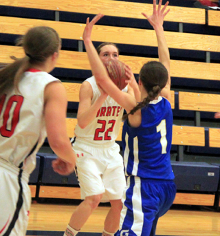 Krystin Uhlenkott sites in a 3-pointer against Genesee. She hit 3 of 4 long distance attempts in the game. At left is Hailey Danly.