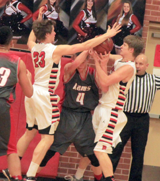 Tanner Ross, right, takes the ball away from a C.V. player after he and Lucas Arnzen trapped him in the corner.