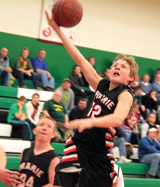Brandon Higgins goes for a transition layup. Also shown is Devin Bruegeman.