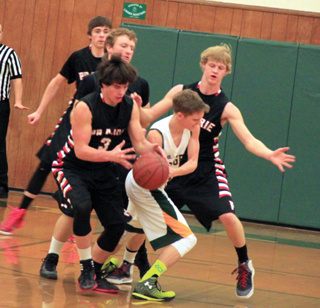 Terran Peery comes up with a steal at Potlatch. Also shown are John Mager, Calvin Hinkelman and Rhett Schlader.
