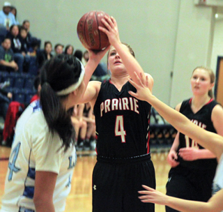 Shayla VonBargen puts up a shot from the key against Lapwai in the District Championship game. At right is Kayla Schumacher.
