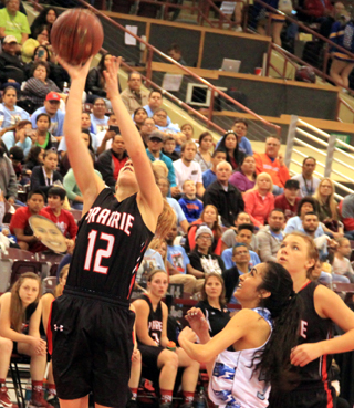 Chaye Uptmor shoots a lay-up against Lapwai. Also shown is Tasha Gimmeson.