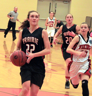 Krystin Uhlenkott goes for a transition lay-up against Challis. Also shown is Hailey Danly.