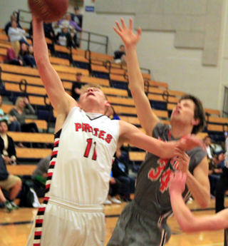 Jake Bruner pulls down a rebound against Troy at District.
