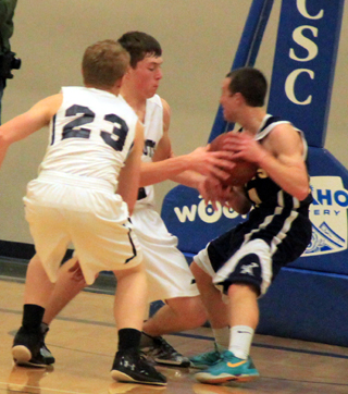 Patrick Chmelik looks to force a jump ball against Logos. #23 is Nathan Beckman.