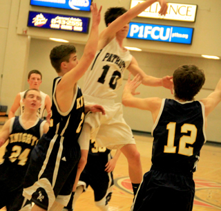Summits Tyler Krogh passes out to the corner after finding the lane clogged with Logos defenders. In the back is Josh Lustig.