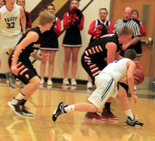 Jake Bruner steals the ball against Valley while Rhett Schlader gets ready to take off downcourt for a transition lay-up.