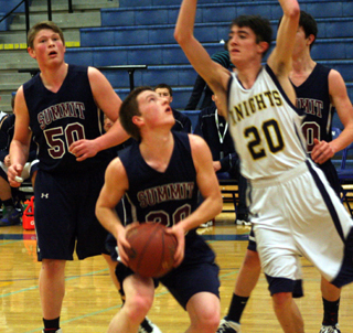 Josh Lustig looks to shoot against Logos. At left is Chris Osborne and at right is Tyler Krogh. Photo by Steve Wherry.