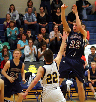 Patrick Chmelik shoots against Logos. Also shown is Nathan Beckman. Photo by Steve Wherry.