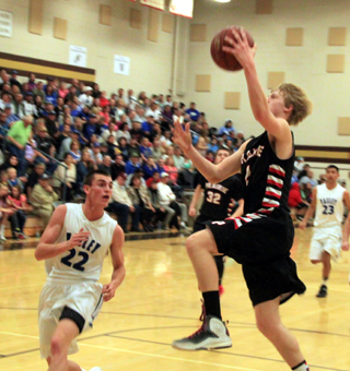 Rhett Schlader swoops in for a lay-up against Valley. This was the result of the steal by Jake Bruner pictured above.