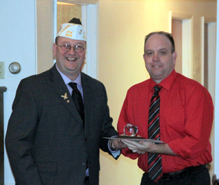 Travis Mader receives his local post VFW teacher of the year award.