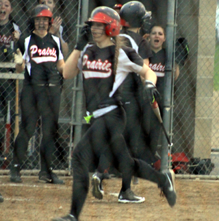 Hailey Danly heads for home as teammates cheer. She hit a game-ending grand slam homer in the first game against Kellogg.