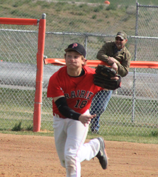 Calvin Hinkelman throws a ball to first for an out. In the background you can see his father, Aaron.