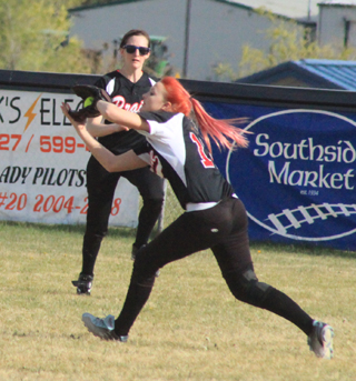 Kellie Heitman makes a catch against McCall. Abbie Uhlenkott comes over to back up the play.