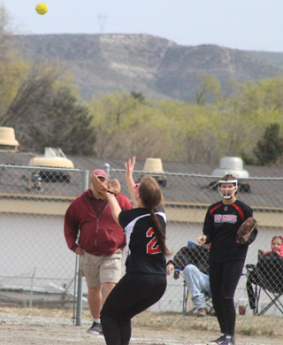 Tasha Gimmeson settles under a popup in the West Side game. Also shown is Hanna Ross.