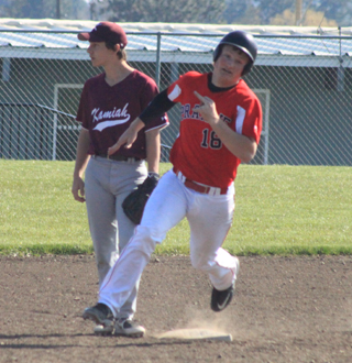 Calvin Hinkelman rounds second and head for third with a triple in the first Kamiah game. He hit for the cycle in the second game.