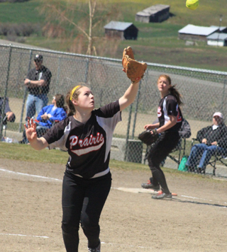 Pitcher Faith Uhlenkott is about to catch a popup against Genesee. Sarah Seubert is in the background.
