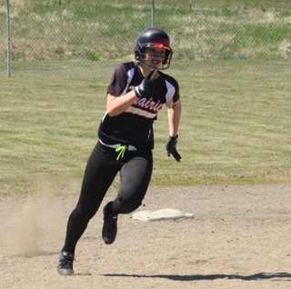 Hailey Danly heads for third with a first inning triple against Genesee. Unfortunately she was unable to score.