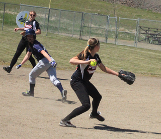 Shortstop Kylie Tidwell is ready to throw the ball over to first for an out in the Genesee game. In the background is second baseman Natasha Gimmeson.