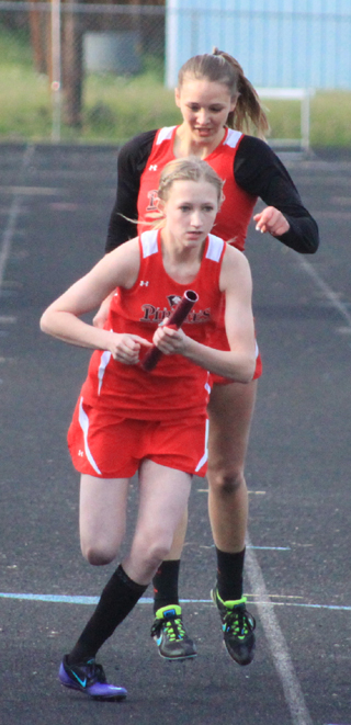 Mykaela McWilliams hands off to Delaney Uhlenkott in second place in the medley relay. Uhlenkott was able to pass her opponent and finish first.