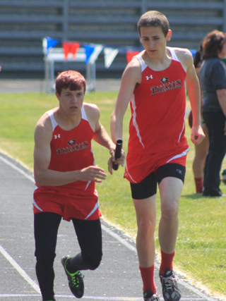 Dally Ratcliff receives the handoff from Anthony Karel for the final leg of the boys medley.