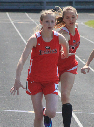 Delaney Uhlenkott takes the handoff from Mykaela McWilliams for the final leg in the same race. Prairie wound up winning the event at the Meet of Champions April 30.