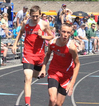Anthony Karel hands off to Sean Spencer in the 4x200 relay.