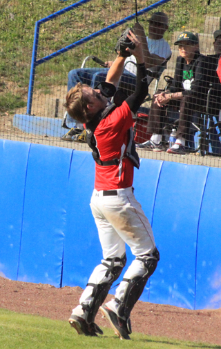 Catcher Devin Bruegeman catches a foul popup behind home plate in the second Potlatch game.
