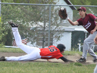 Jace Perrin dives back into first to beat a pickoff attempt against Kamiah.