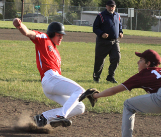 Jake Bruner slides into third with a triple against Kamiah.