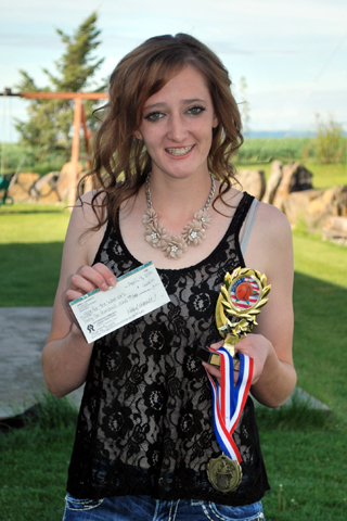 Abbie Uhlenkott with the $6600 check for funds raised from her senior project fundraiser.