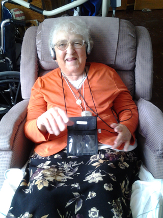 Sister Angela listening to a customized playlist on her iPod as part of the MUSIC & MEMORY program.