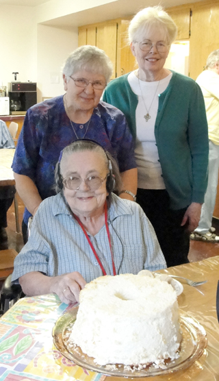 Sister Chanelle and Sister Clarissa help celebrate Sister Louise's birthday in the Second Floor Dining Room.
