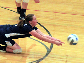 Bridget Beckman hits the floor to dig up a Deary serve.