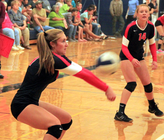 Krystin Uhlenkott makes a pass. Also shown is Sarah Seubert.
