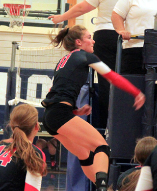Krystin Uhlenkott pounds a spike against Grangeville at the Jamboree. Also shown are Sarah Seubert and Hailey Danly.