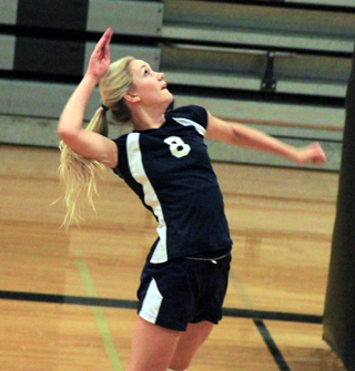 Lauren Stubbers goes up for a spike as teammates, from bottom, Lucy Osborne, Rachel Waters and Taylor Lustig watch.