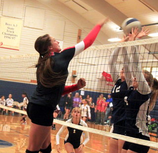 Shayla VonBargen gets a spike past two Grangeville blockers.