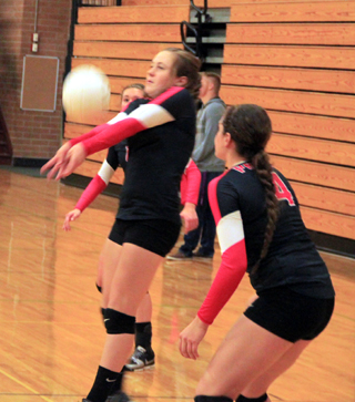Angela Wemhoff makes a pass at the Border Battle. Also shown are Shayla VonBargen and Mykaela McWilliams (hidden).