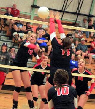 Chaye Uptmor spikes the ball past an Asotin blocker. Also shown are Shayla VonBargen and Sarah Seubert.