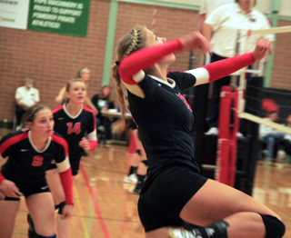 Chaye Uptmor winds up for a spike at the Border Battle in Pomeroy. Also shown are Hailey Danly and Sarah Seubert.